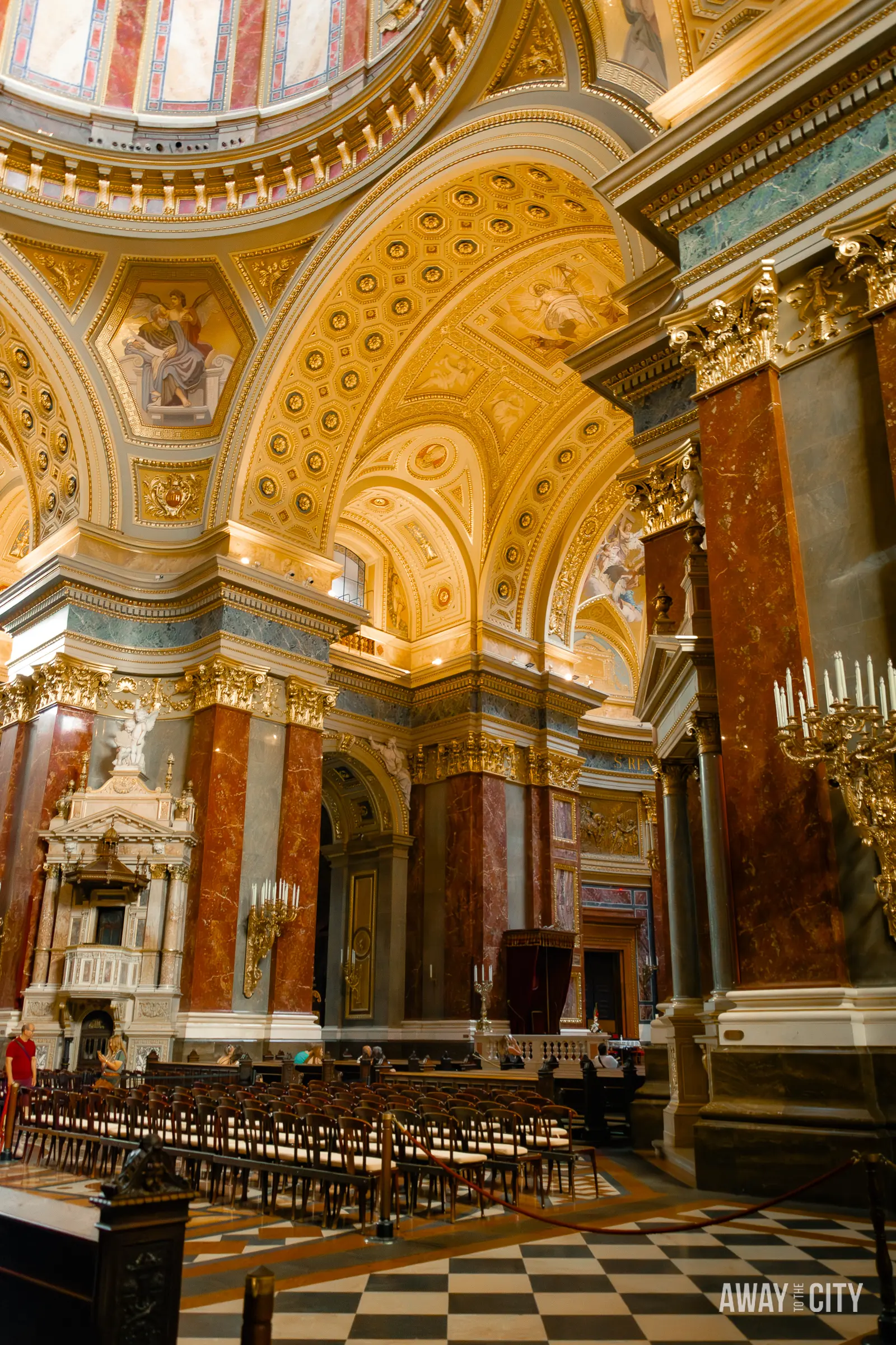 A view of the inside of St. Stephen's Basilica with its dome, adorned with intricate architectural details