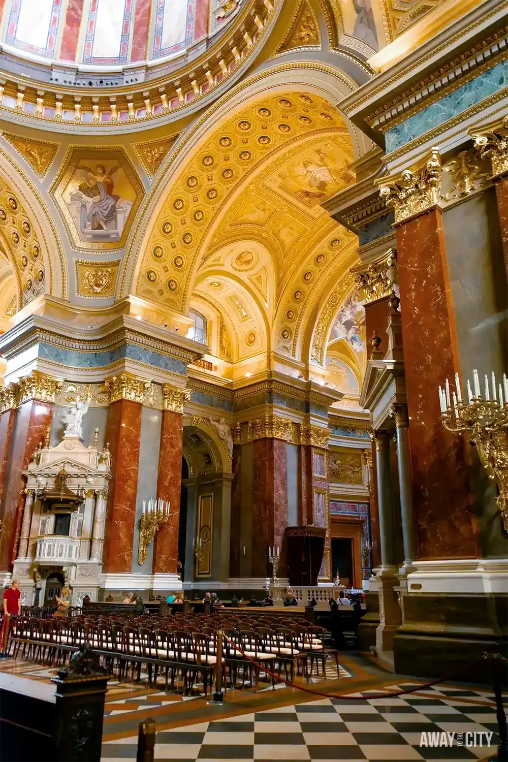 A view of the inside of St. Stephen's Basilica with its dome, adorned with intricate architectural details