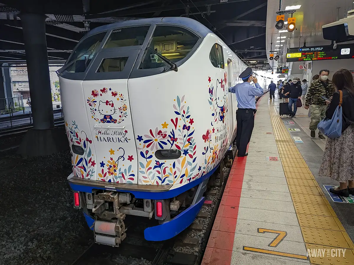 A Japanese Haruka train with Hello Kitty print, known for its unparalleled punctuality and reliability, exemplifying Japan's efficient transportation system