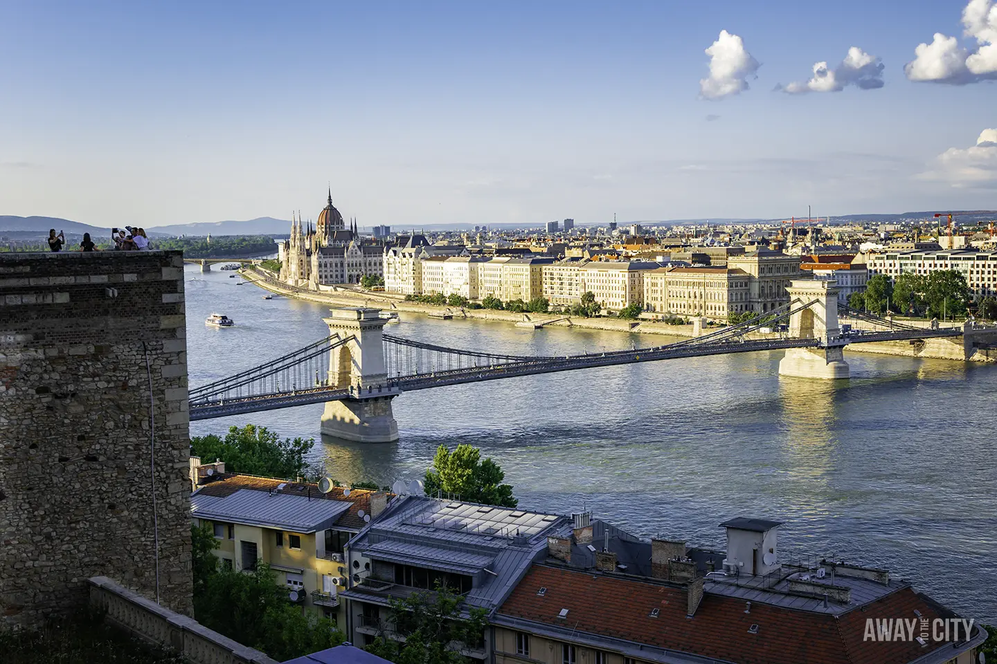 A view from Castle Hill in Budapest, capturing the Chain Bridge and Hungarian Parliament Building along the Danube river.