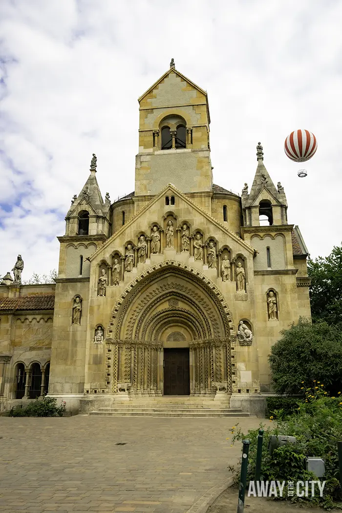 Vajdahunyad Castle in Budapest City Park, with a hot-air balloon in the background.