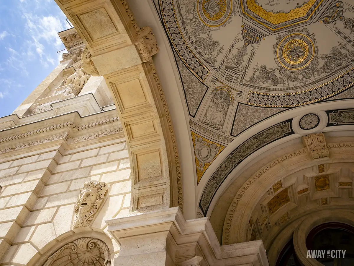 View of the archway of the facade of the Hungarian State Opera House in Budapest, Hungary, displaying intricate architectural details.