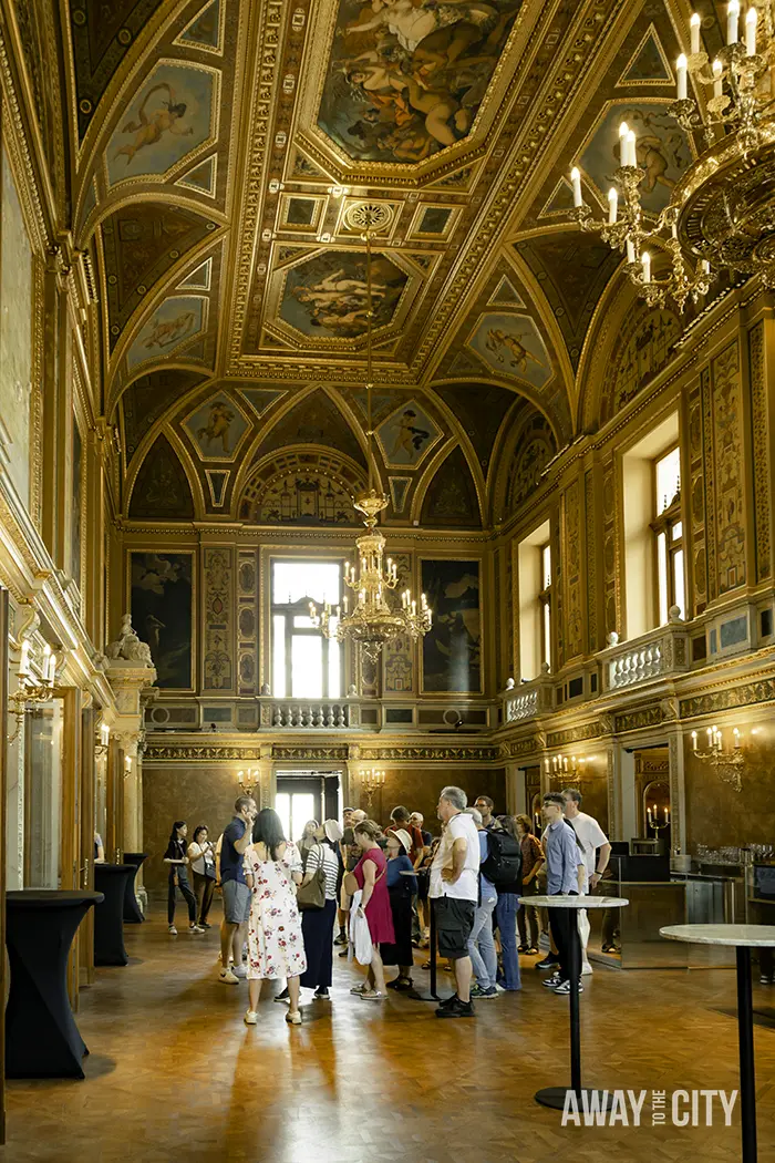 A guided tour at the Hungarian State Opera in Budapest, with visitors in the room with the Feszty Bar.