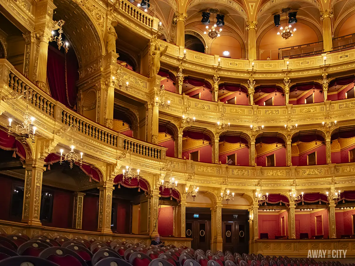 View of the boxes and seating area inside the Hungarian State Opera in Budapest during a guided tour.