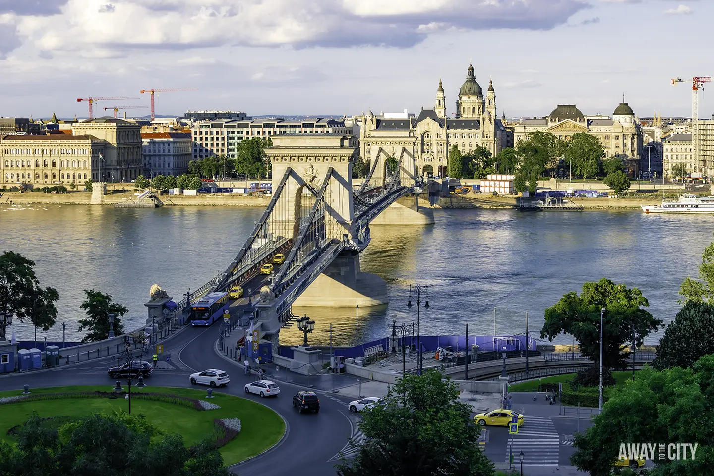 A view from Buda Castle in Budapest, featuring the iconic stone lions that guard the Szechenyi Chain Bridge.