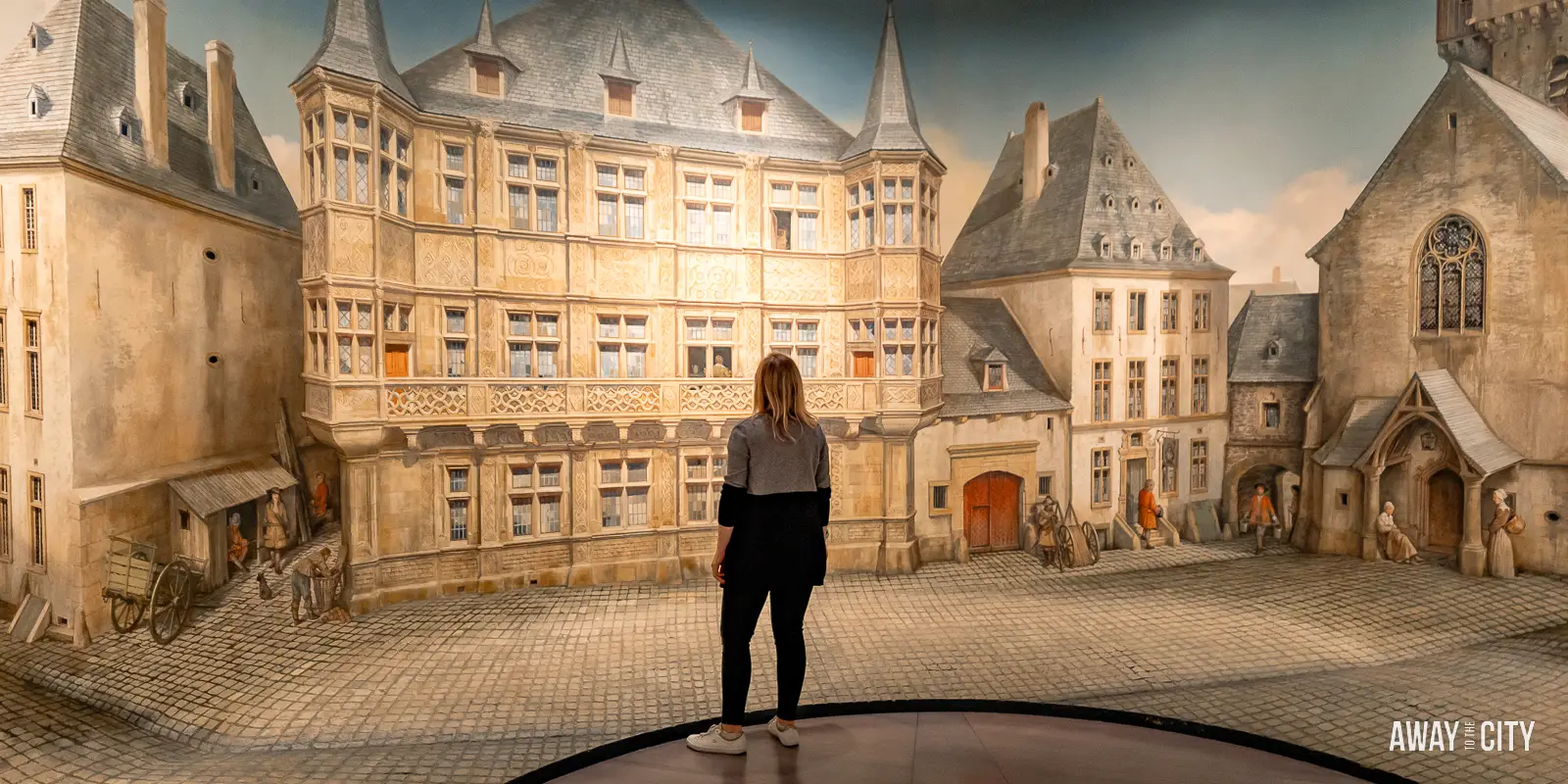 A person standing in front of a mural in the Letzebuerg City Museum in Luxembourg City