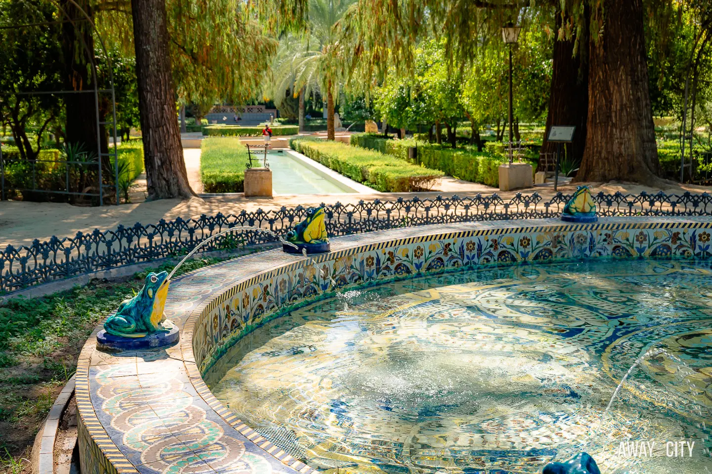 A picture of Fuente de las Ranas (Fountain of the Frogs) in Parque de María Luisa, Seville, showcasing a charming frog-themed fountain.