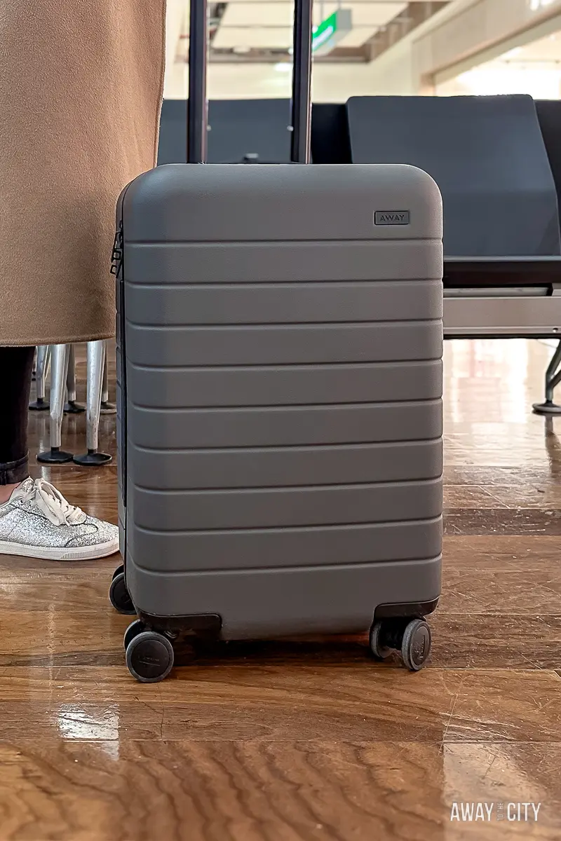 A picture of the Original Carry-On suitcase from the travel gear brand Away, a sleek and stylish suitcase for jet-setters and adventurers, making it a perfect gift for travellers.