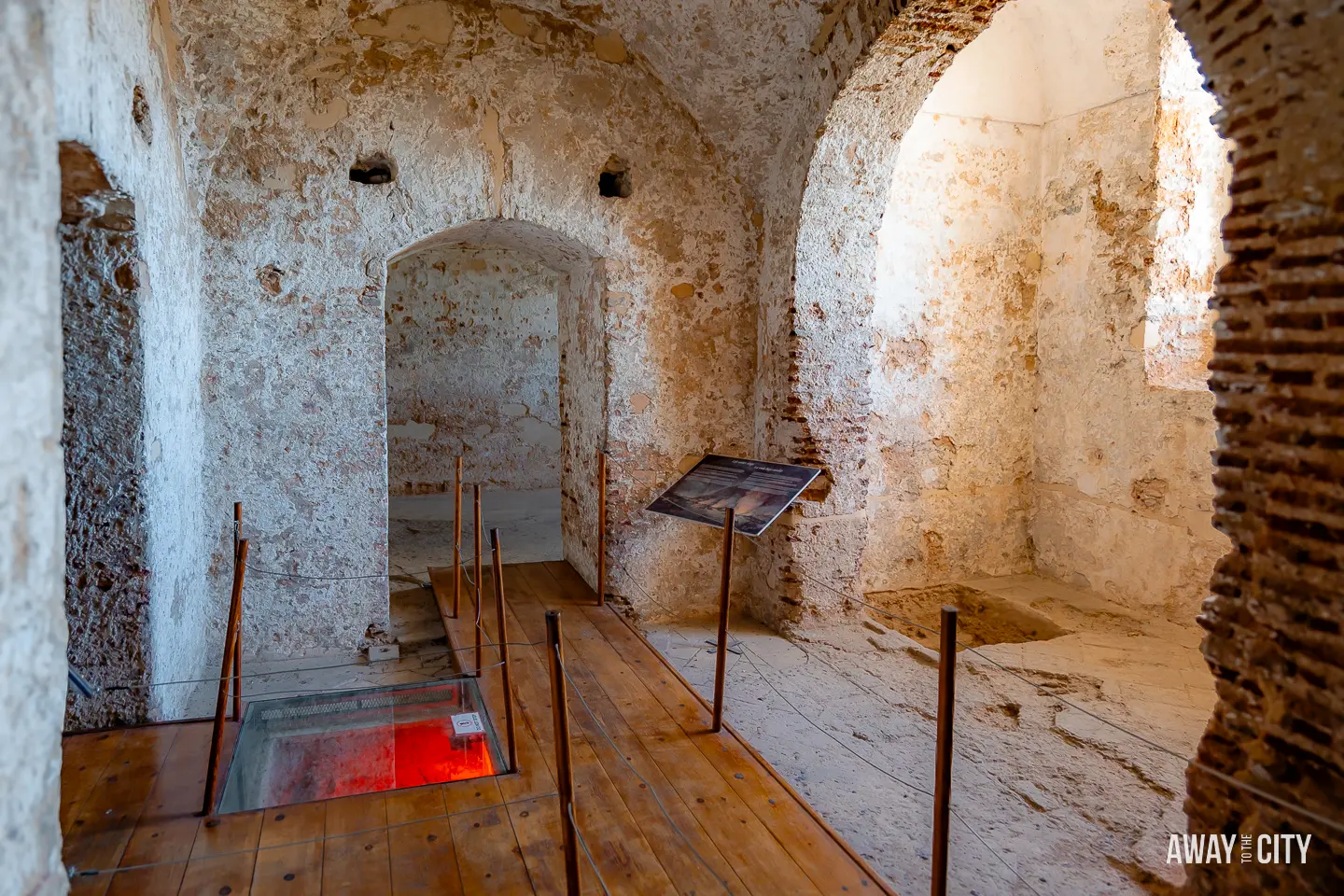A picture of one of the rooms of Moorish Castle in Gibraltar with a wooden floor, offering a glimpse into the interior ambience and historical architecture of the castle.