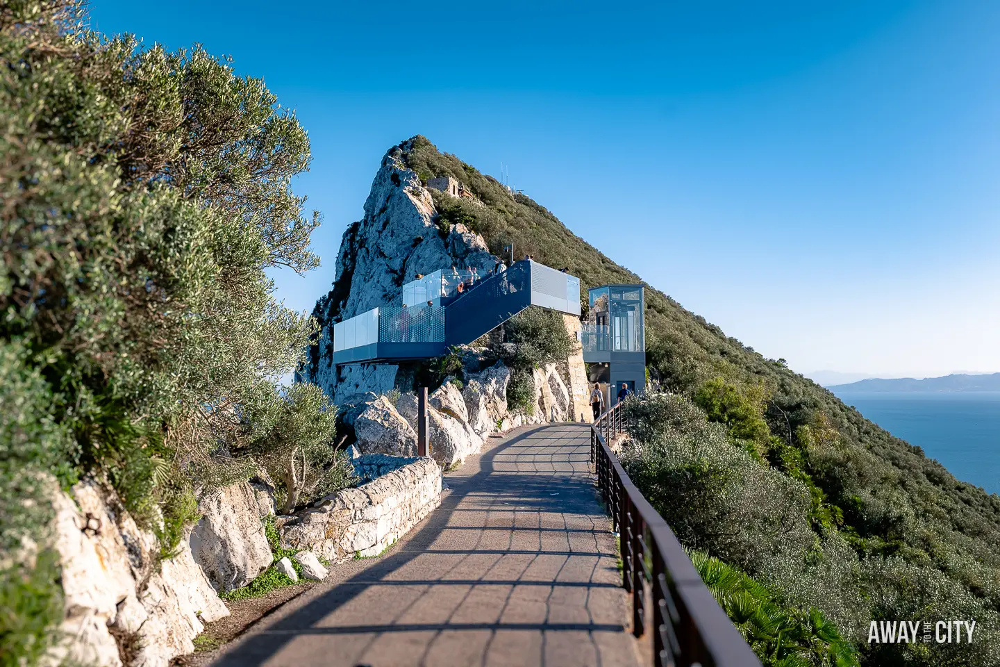 A picture of glass walkways at the summit of the Rock of Gibraltar, called "The Skywalk" at the summit of Gibraltar Rock, offering a breathtaking panoramic view of the surrounding landscape and the vast sky."