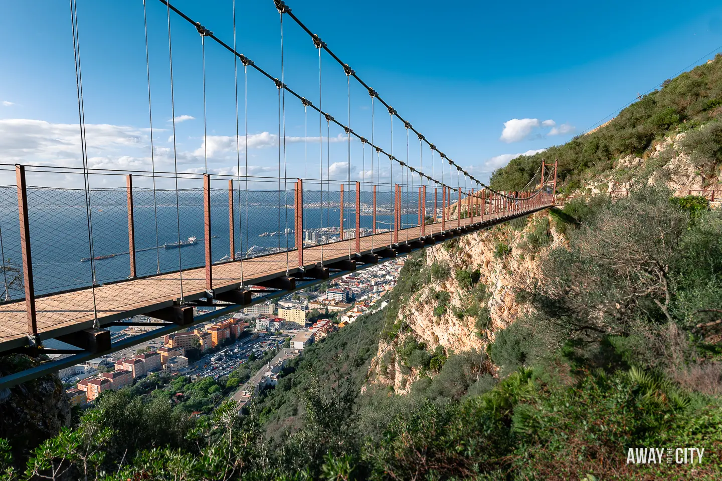A picture of Windsor Suspension Bridge in Gibraltar and the city of Gibraltar underneath, showcasing the scenic landscape and urban surroundings.