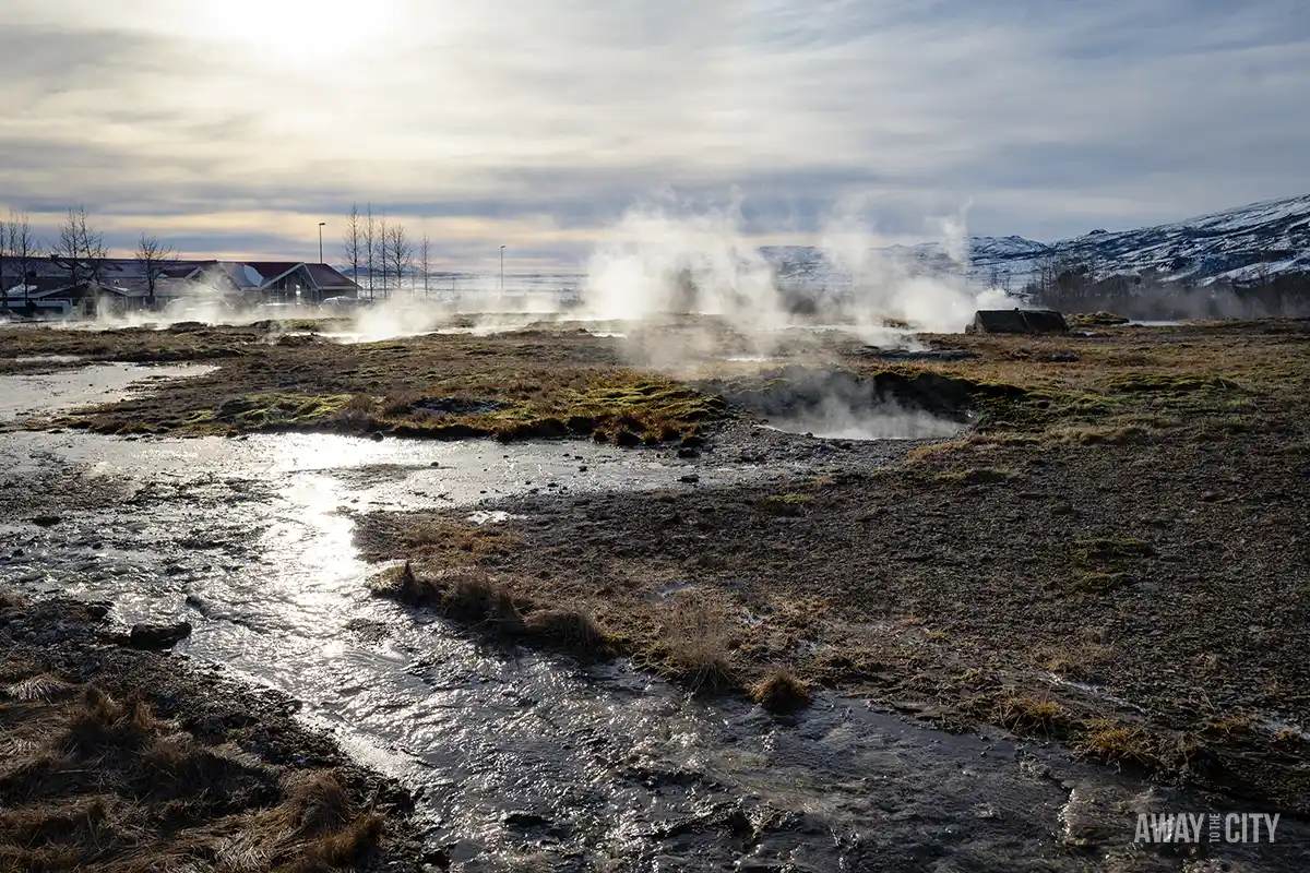 A hot spring in a field at the Geysir Geothermal Area where you can witness erupting geysers and bubbling mud pools on a Golden Circle day tour from Reykjavik, one of the best things to do in winter.