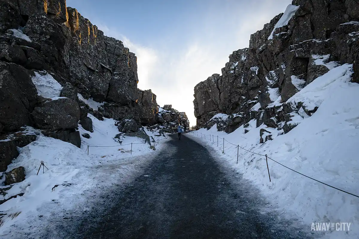 A road with snow on the side at the Þingvellir National Park, one of the main attractions of the Golden Circle day tour about a 40-minute drive from Reykjavík.