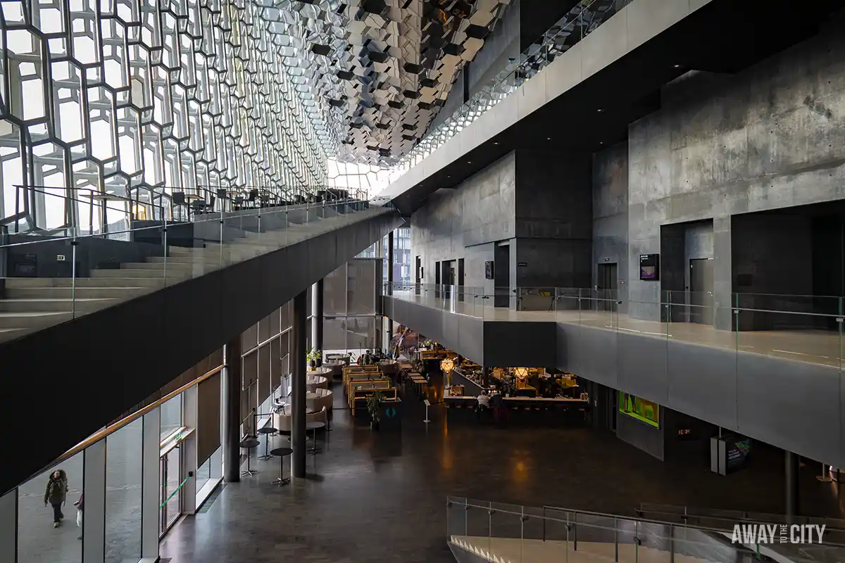 A large building from the inside and its hexagonal glass façade, taken at the Harpa concert hall in Reykjavik, one of the must-see spots in Iceland's capital in winter.
