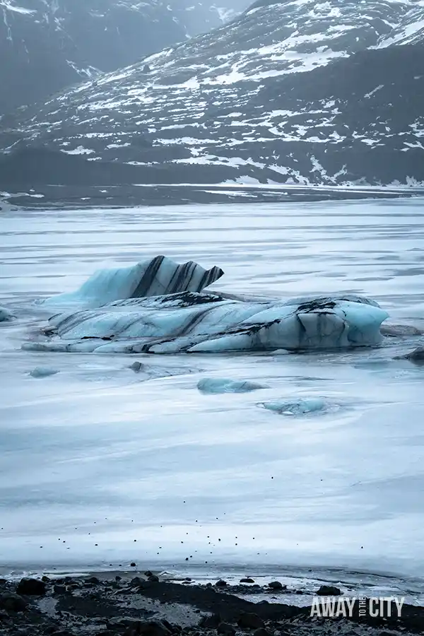 Ice from Sólheimajökull Glacier floating in the water in Iceland.