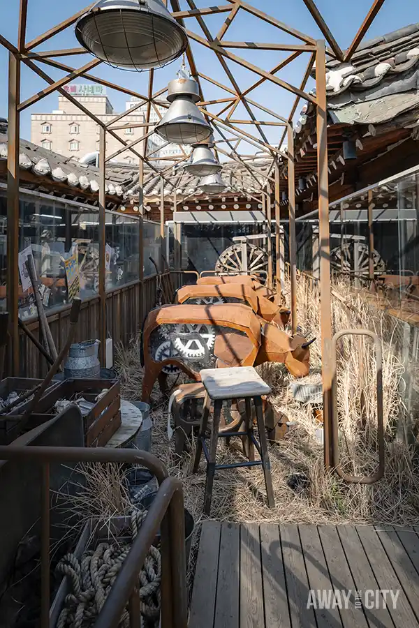 A group of mechanic cows in front of the entrance of Cheese Industry in Ikseon-dong Hanok Village, one of the many themed cafés in Seoul.
