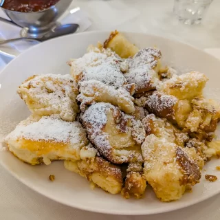 A plate of Kaiserschmarrn on a table at the coffee house Café Central in Vienna.