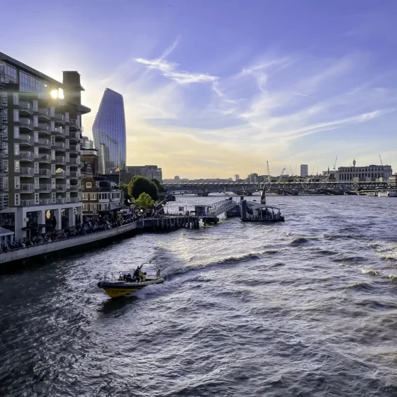 A boat on the water, with the Southwark district in the background.