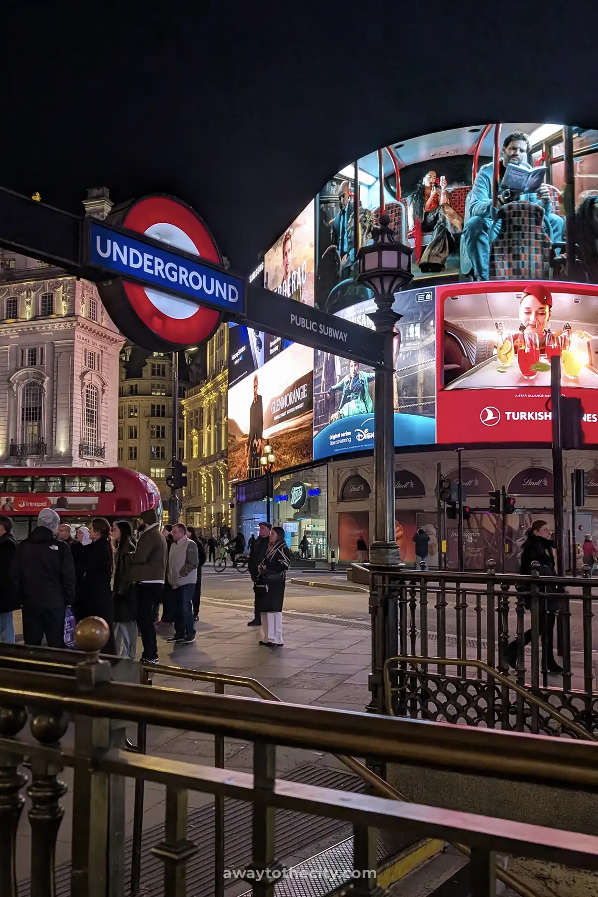 Piccadilly Circus is alive at night with illuminated billboards and the iconic Underground sign.
