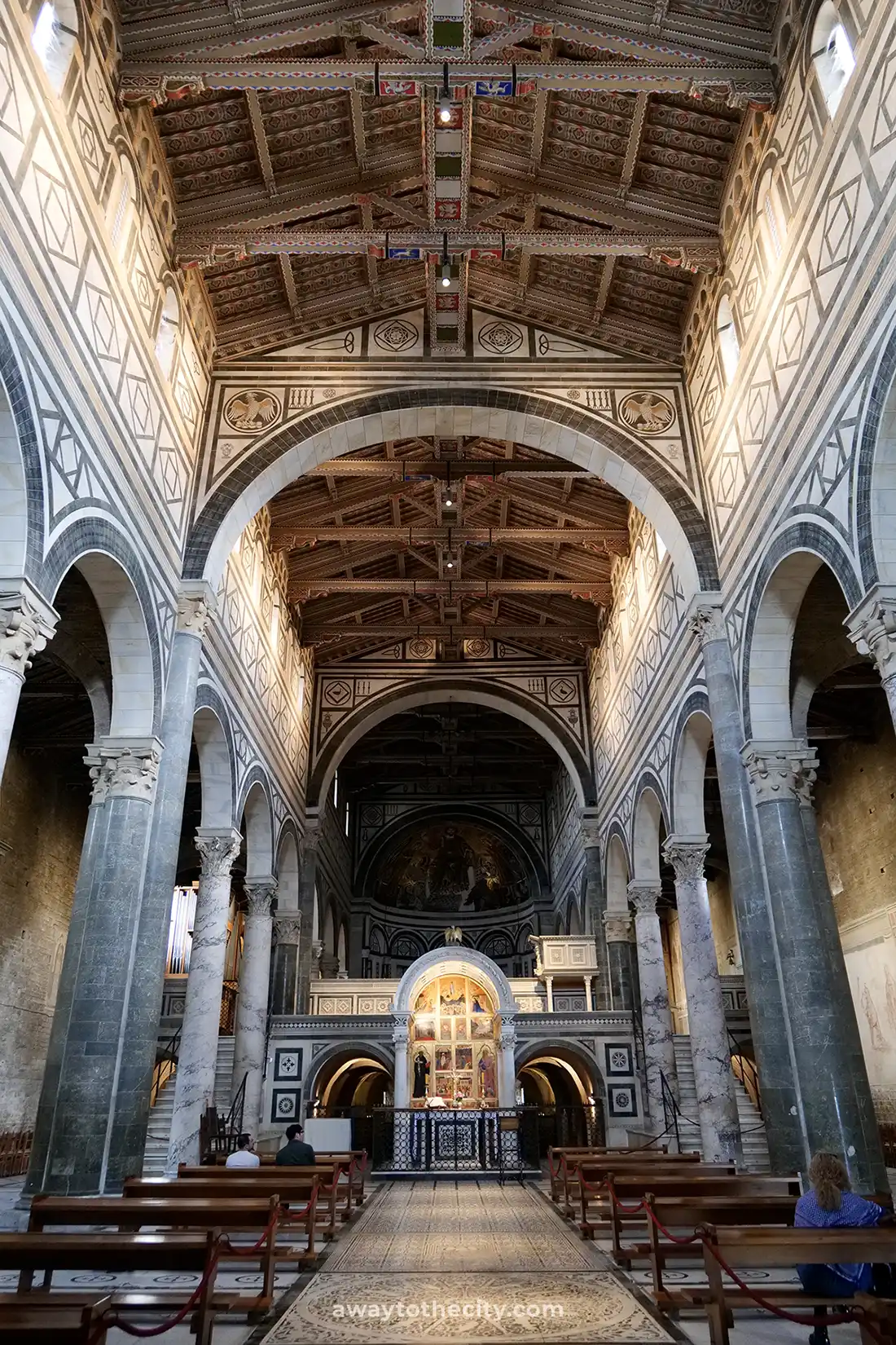 The ornate interior of the Basilica di San Miniato al Monte gleams.