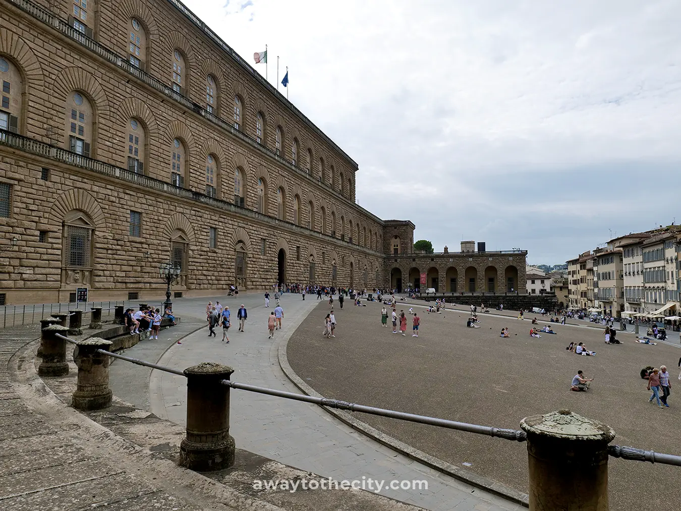 The grand facade of Pitti Palace overlooks the meticulously arranged Boboli Gardens, with Florence's Duomo visible in the distance.