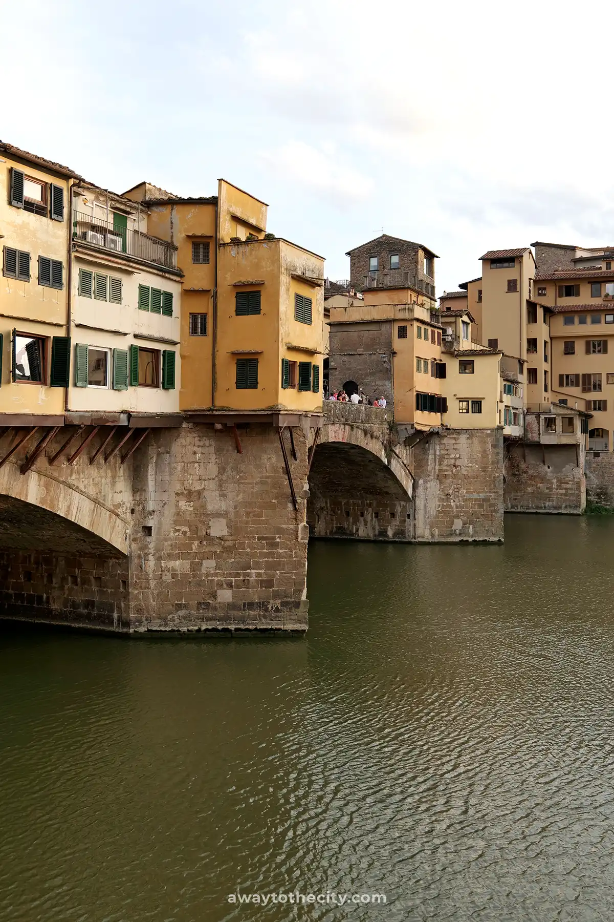 The Ponte Vecchio, with its unique shops built along it, stretches across the Arno River in Florence.