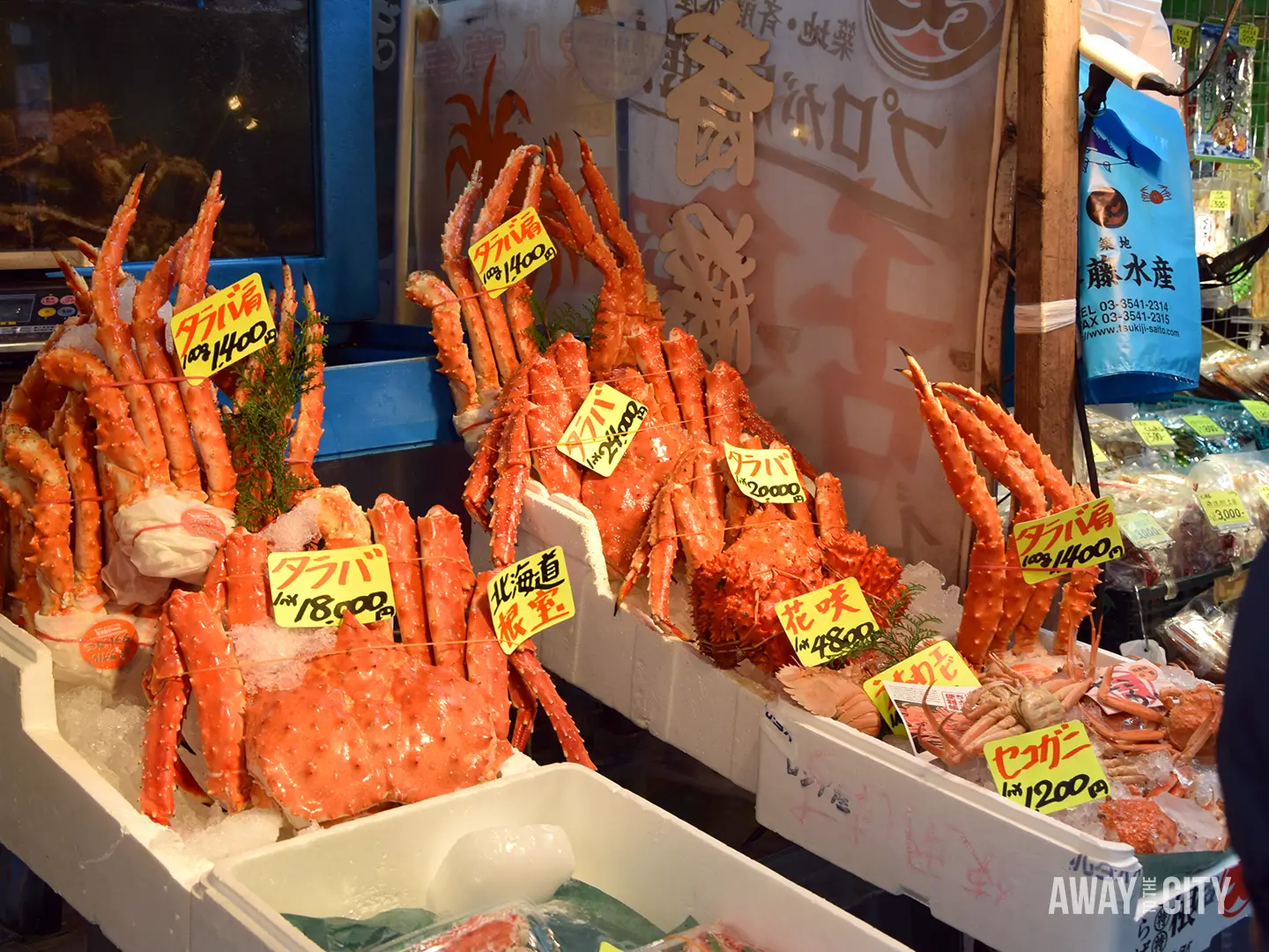 Display of large red crabs arranged on ice at a Japanese seafood market stall at the Tsukiji Fish Market, one of the things that can easily be skipped in Tokyo.