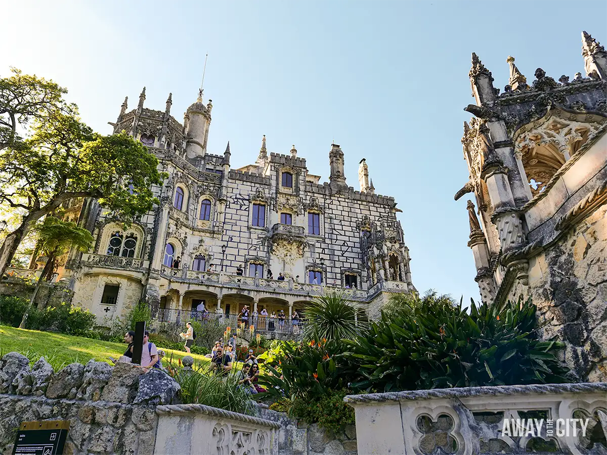 Exterior view of Quinta da Regaleira in Sintra, showcasing the elaborate palace façade, gardens and Gothic-inspired architecture.