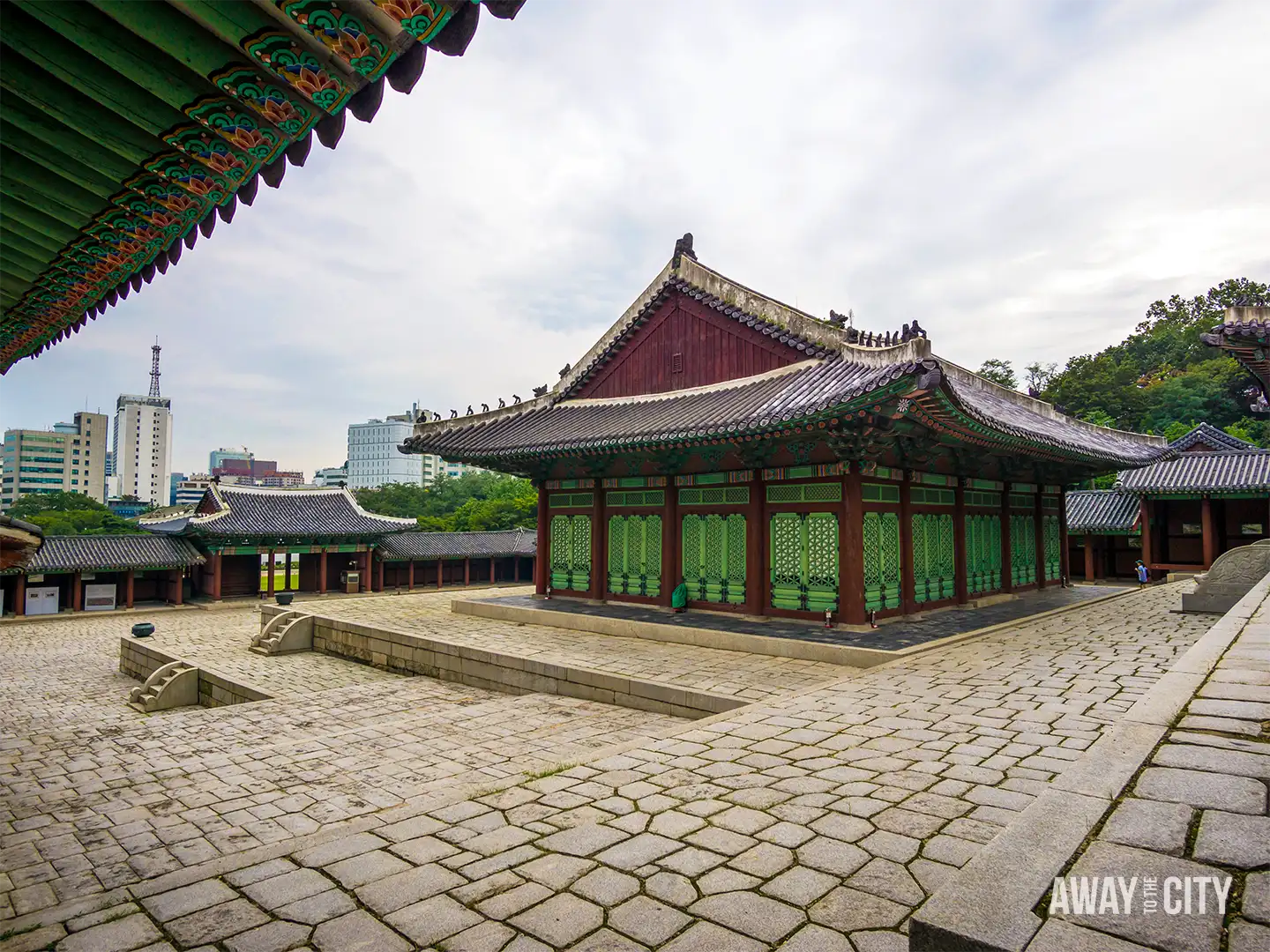 Stone-paved courtyard at Gyeonghuigung Palace in Seoul, surrounded by traditional Korean halls.