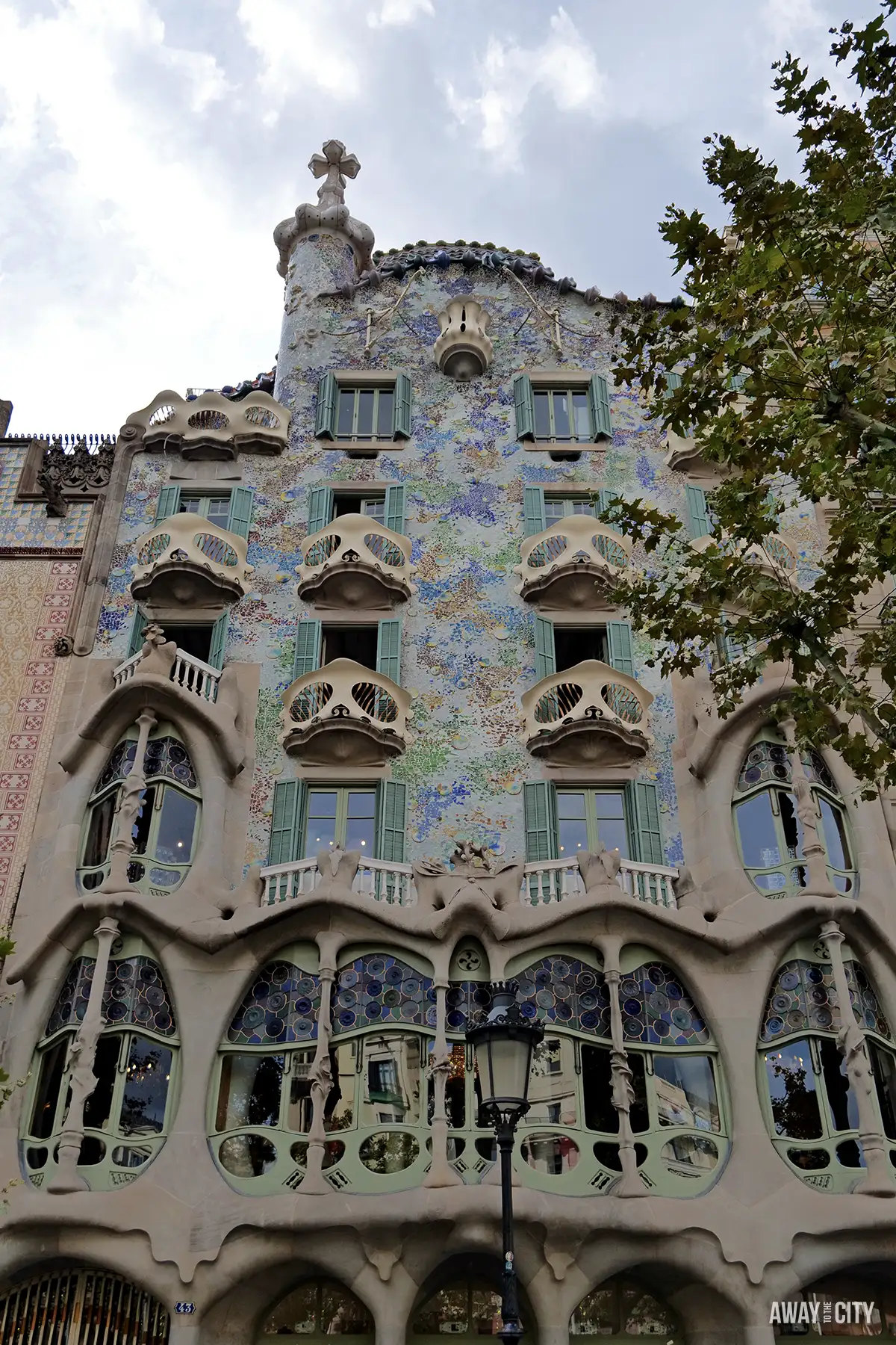 A close-up of the famous exterior of Gaudí's Casa Batlló shows its colourful mosaic and whimsical balconies, one of the best things to do in Barcelona.