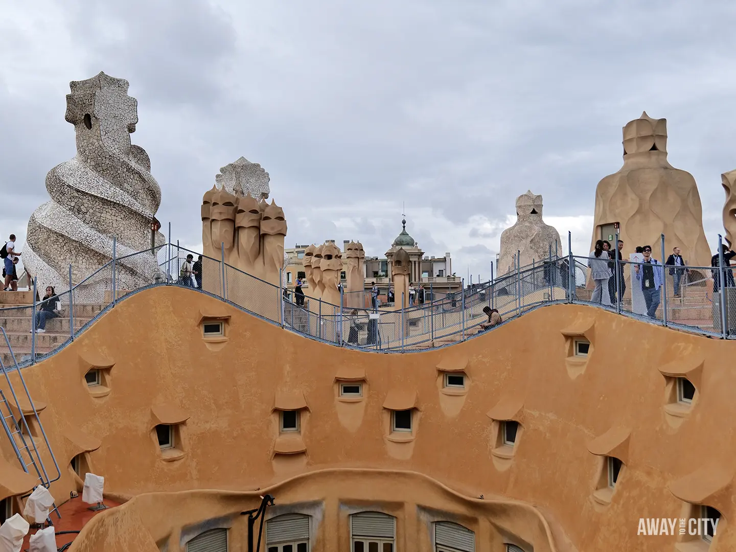 The iconic, undulating rooftop of La Pedrera (Casa Milà) in Barcelona, featuring Gaudí's surreal chimney sculptures and visitor walkways.