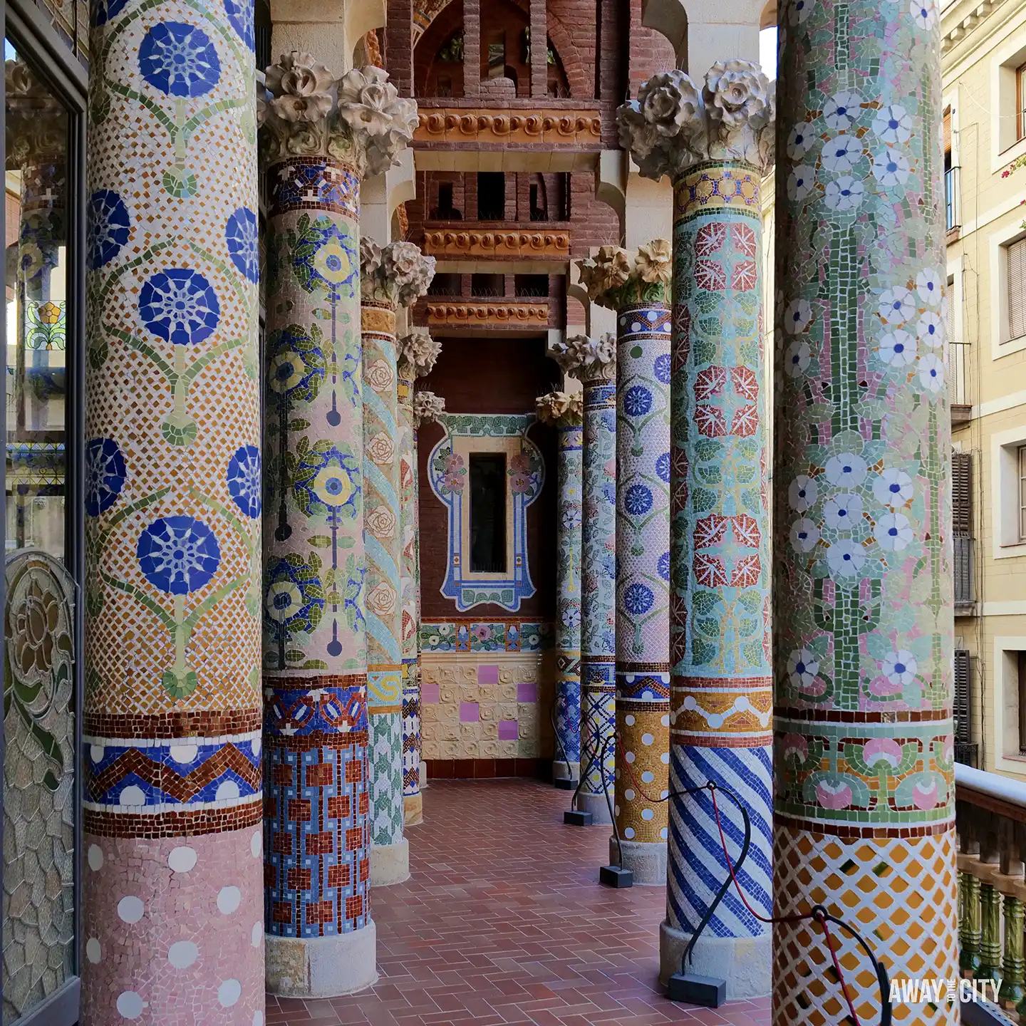 The highly decorative Lluís Millet Balcony at the Palau de la Música Catalana, featuring mosaic-tiled columns and capitals.