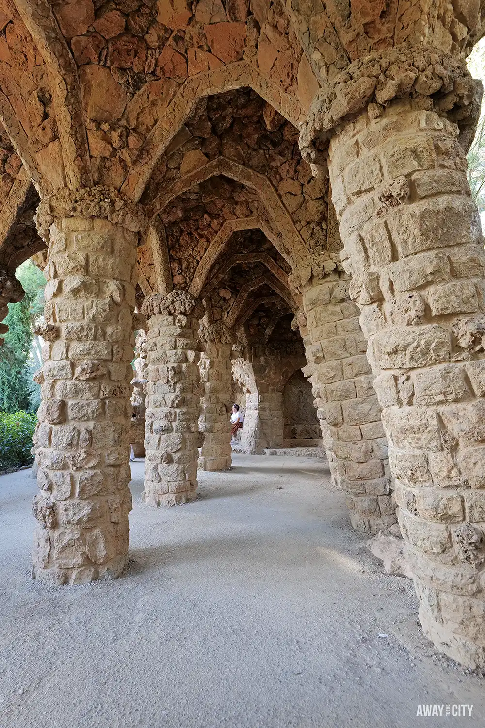 A historical view of the tiered wooden operating theatre at the Old Operating Theatre Museum in London.
Rough-hewn stone columns support the vaulted ceiling of a Park Güell viaduct walkway in Barcelona.