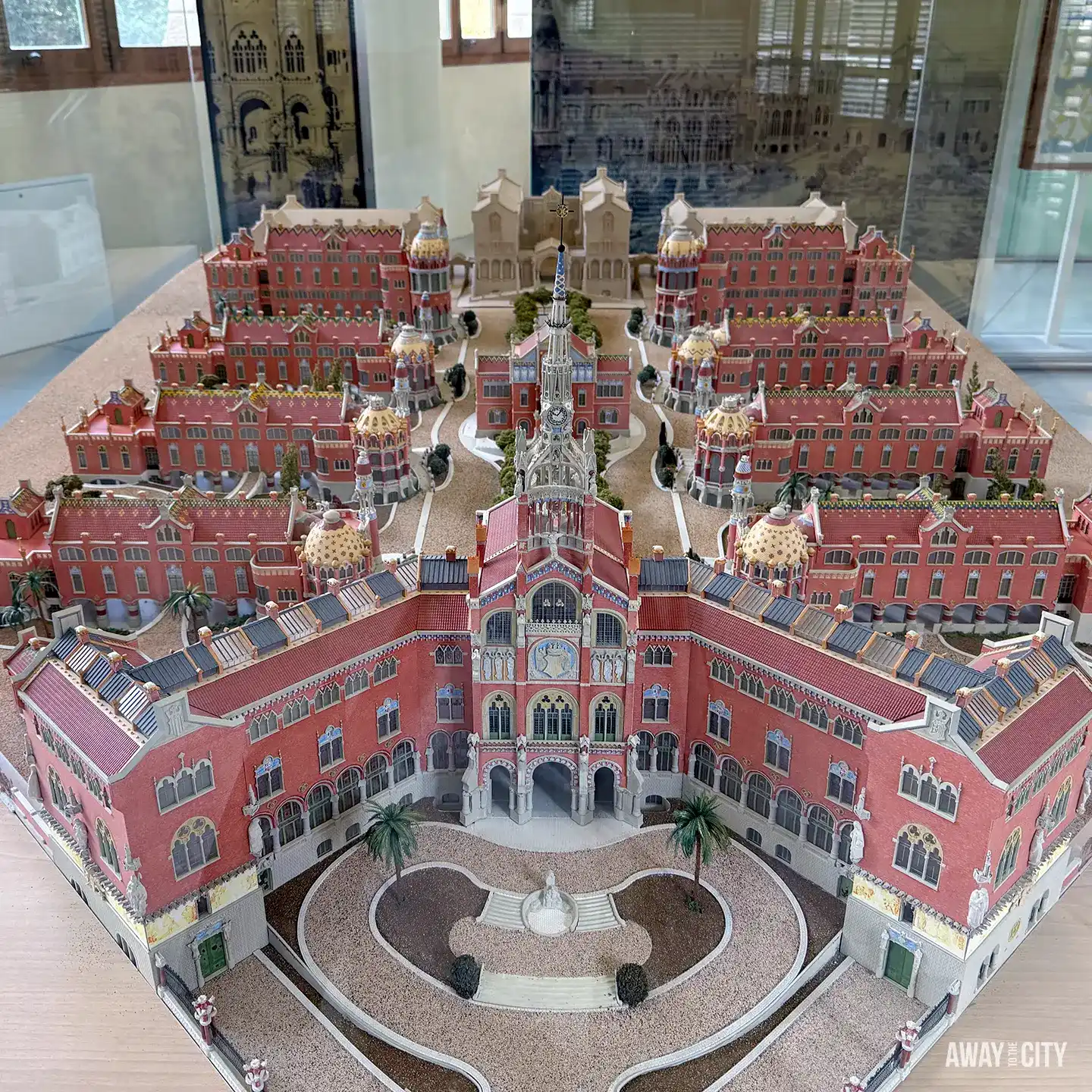 A detailed architectural model of the Sant Pau Recinte Modernista in Barcelona, showing the red brick hospital pavilions.