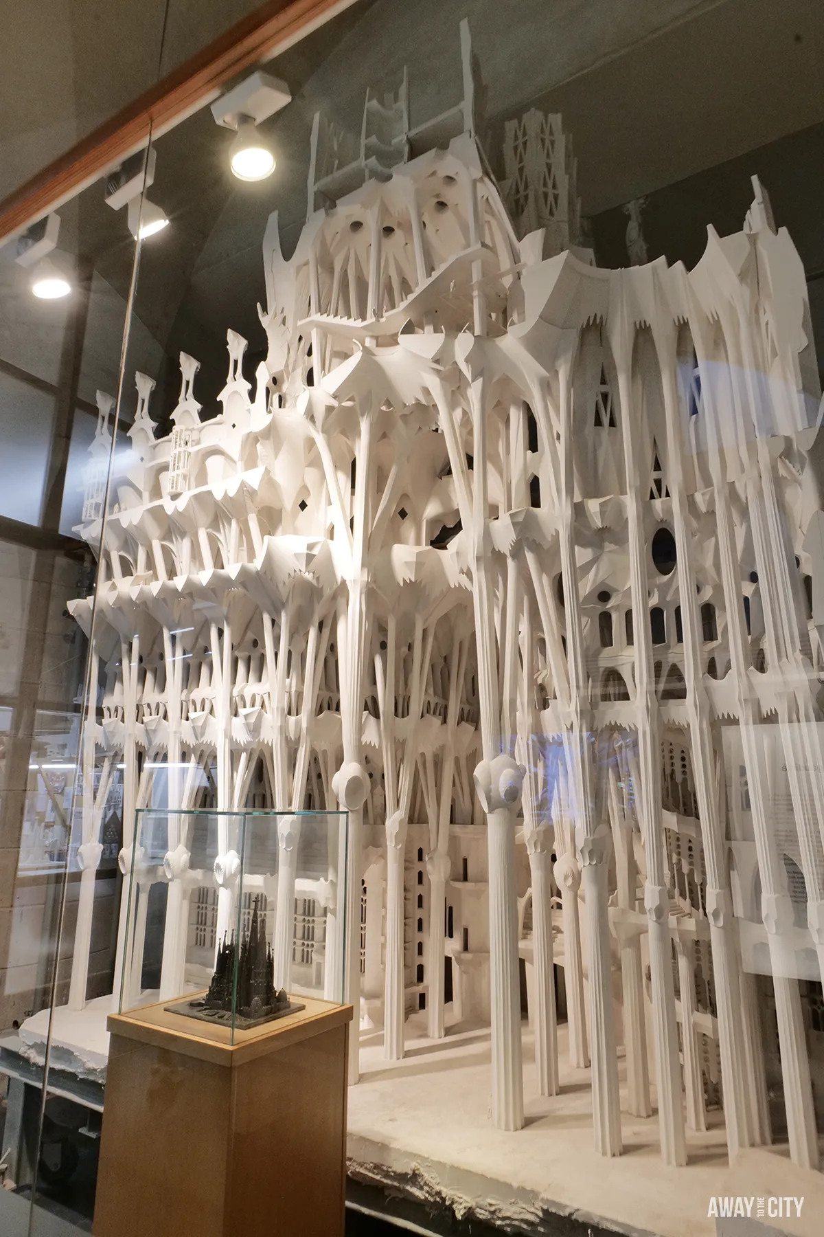 A detailed plaster model of the Sagrada Família's complex structure is displayed behind glass in the museum.