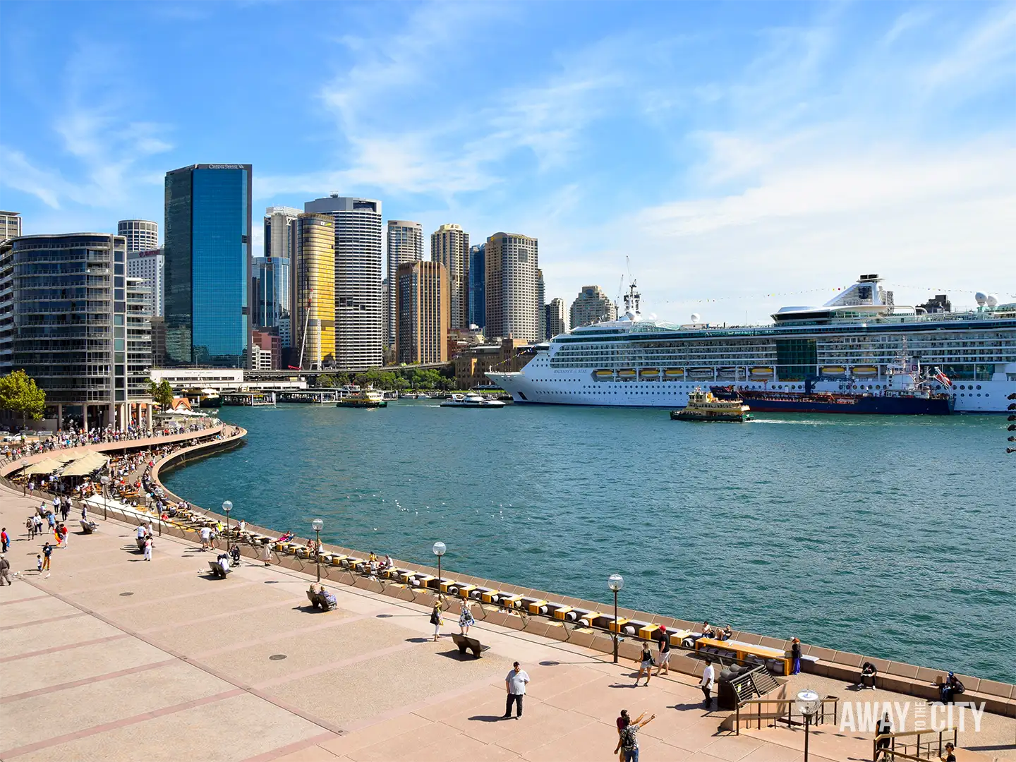 View across Sydney Cove towards Circular Quay with a large cruise ship docked in the harbour.