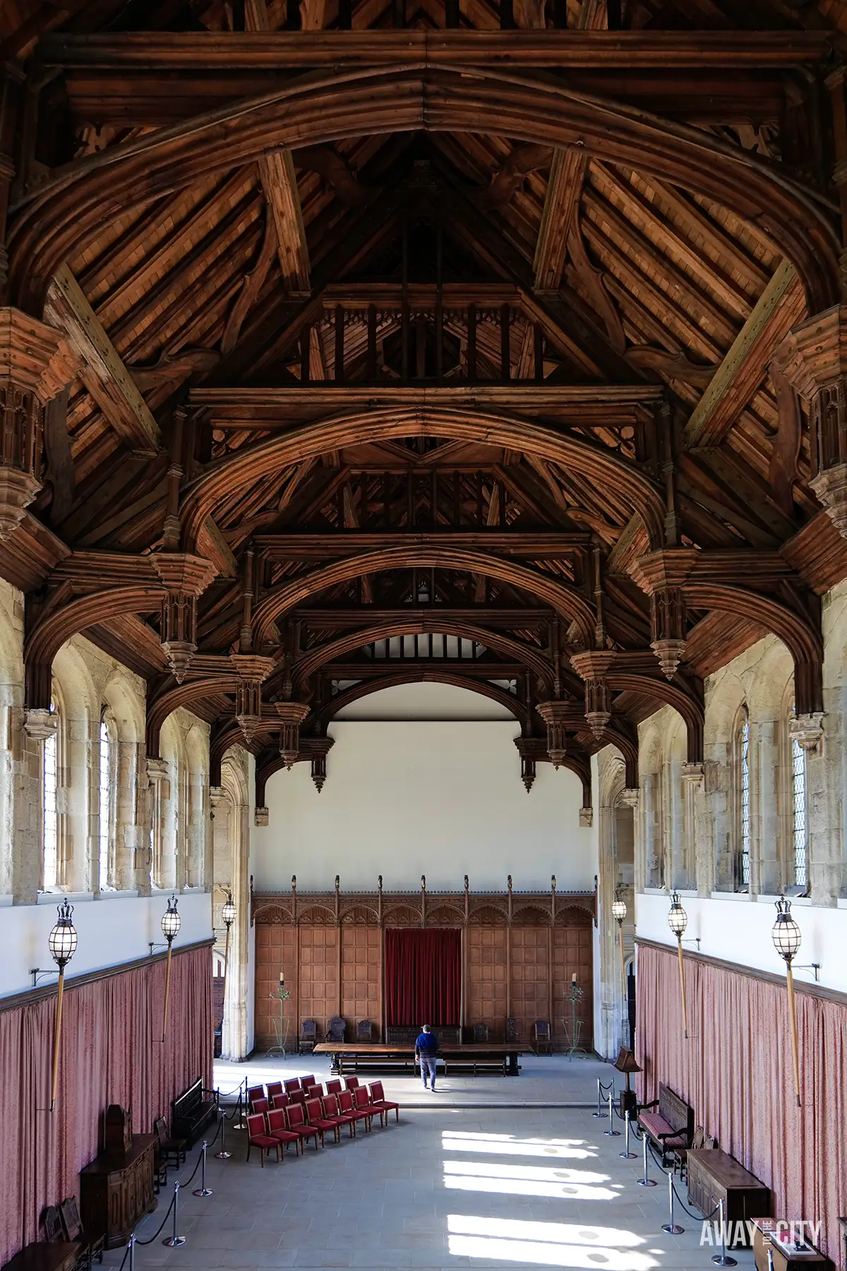 The Great Hall at Eltham Palace showcases its impressive medieval hammerbeam roof, large windows, and historic wooden panelling, making it a fascinating stop on one of the best day trips from London.