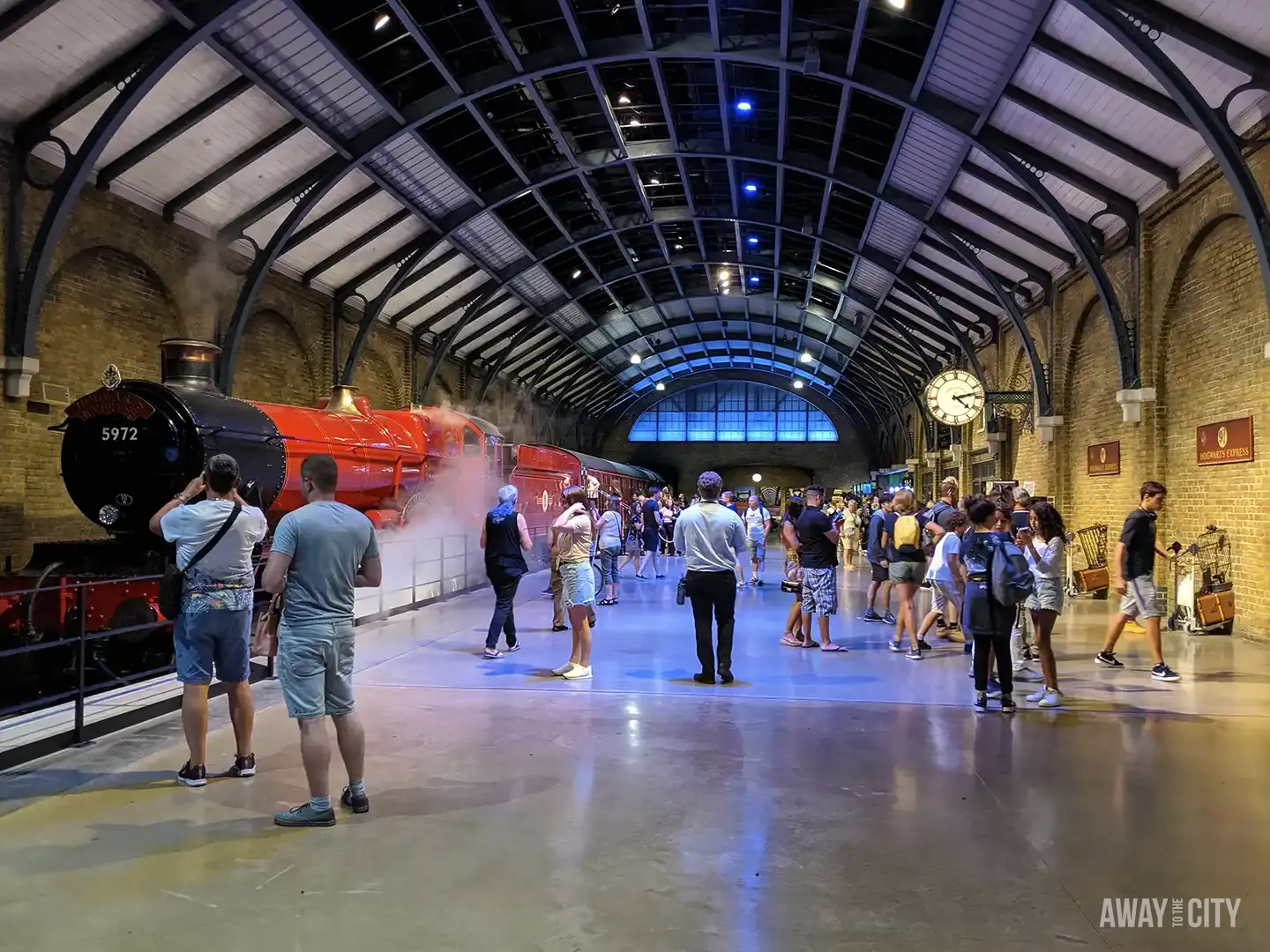 Visitors gather on a platform to see the Hogwarts Express steam train at the Warner Bros Studio Tour.