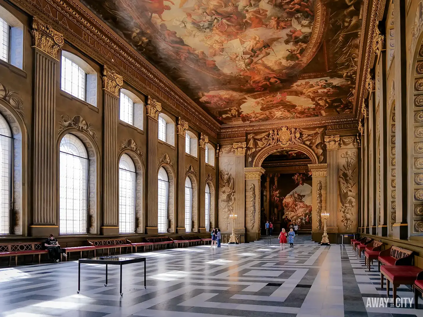 The long and ornate Painted Hall at the Old Royal Naval College, with a magnificent ceiling mural and marble floor.