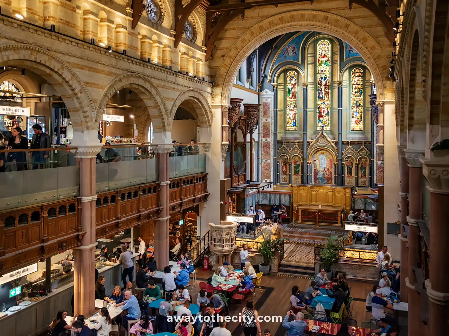 Mercato Mayfair food hall, a transformed church, is bustling with people dining in its various levels.